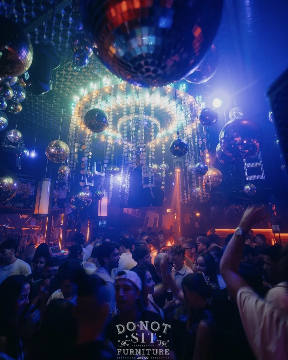 Mirrorballs above a full floor at an Intriga night